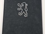 a black book with a white lion on it sitting on top of a table