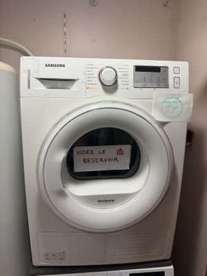 a washing machine with a sign on the front of it