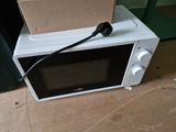 a microwave that has a box on top of it