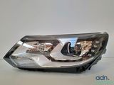 a close up of a headlight of a car on a white surface