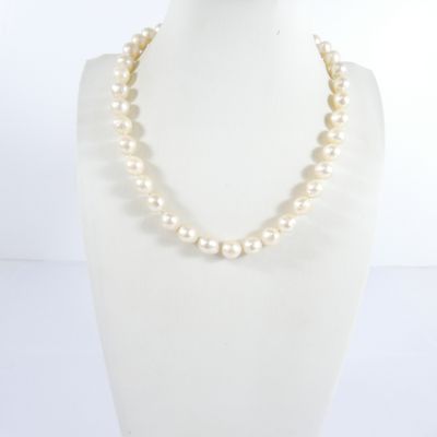 un collier blanc orné de perles autour du cou d'un mannequin