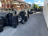 a lot of black trash bags sitting on the side of the road