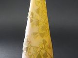 un vase jaune posé sur une table noire