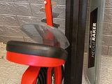 a red scooter that is sitting on the floor