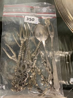 a bag of forks and spoons sitting on a table