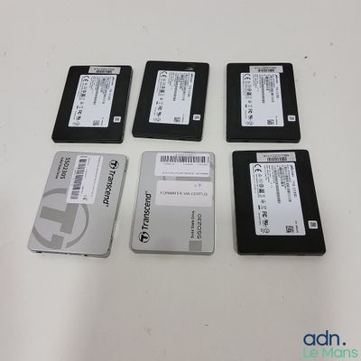 several hard drives are lined up on a white surface
