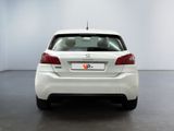 the rear end of a white car in a white room