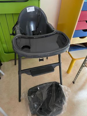 a baby high chair in the middle of a room