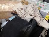 a black bag with a scarf on top of it