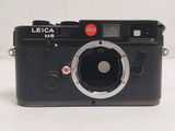 a black camera with a red button on it