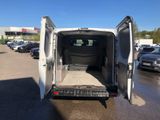 the back of a white van with its doors open in a parking lot