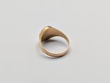 a close up of a gold ring on a white surface