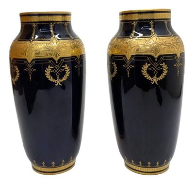 pair of black and gold vases on a white background