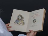 a woman holding an open book in her hands