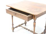 a small wooden table with a drawer on it