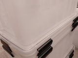 two large white coolers stacked on top of each other in a room