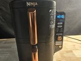 a coffee maker and a remote control on a table