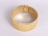 gold mesh bracelet with a square clasp on a white background