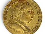 a close up of a gold coin on a white surface