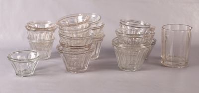 a lot of glass vases and glasses on the table
