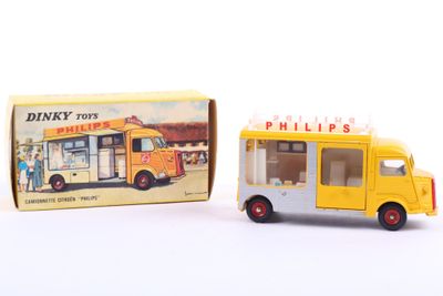 a small yellow toy bus next to a box of pills