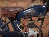 a motorcycle that is parked in front of a brick wall