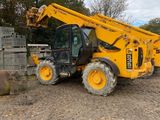 a yellow crane that is sitting in the dirt