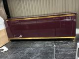 un buffet bordeaux et or dans un entrepôt, avec des cartons et une chaise
