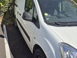 a white van that is parked in a parking lot