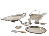 a silver plate with a basket on top of it