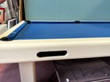 a pool table that has a blue cloth on it