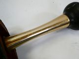 a black and gold pipe sitting on top of a white table