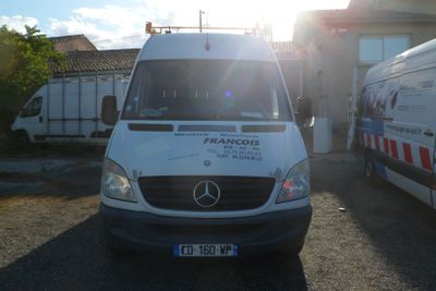 a white van parked in front of a building