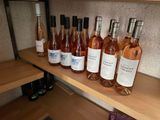several bottles of wine are lined up on a shelf in a wine cellar