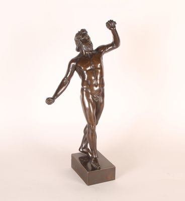 statue en bronze représentant un homme tenant une balle de tennis, posée sur un socle en bois
