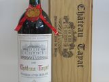 a bottle of wine sitting next to a wooden box