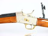 the rifle is made of wood and has a brass plated handle
