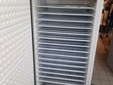 a white refrigerator that is open in a store