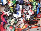 a box full of toy cars that are sitting on the floor