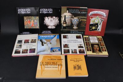 several books on a black table with a black chair in the background