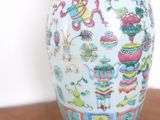 a vase that is sitting on a table with a lamp on it