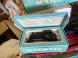 a box with a train in it sitting on top of a pile of other boxes
