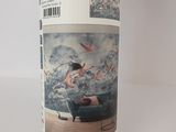 a bottle of wine with a picture of a woman sitting on a couch