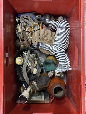 a red box filled with assorted items and a zebra