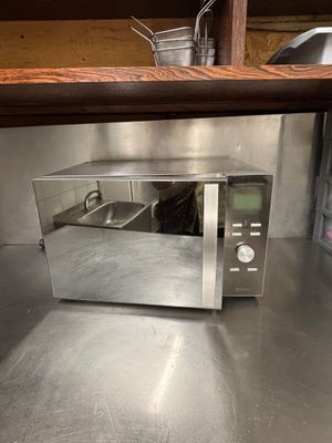 a microwave that is sitting on a counter in a kitchen