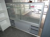 a glass display case in the corner of a room