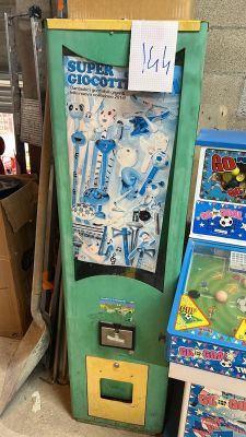 a green and yellow vending machine next to a box of candy