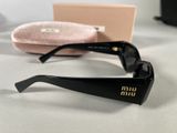 black sunglasses with a pink case and a pair of sunglasses on a table