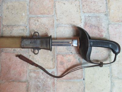 a knife that is laying on the ground next to a clamp