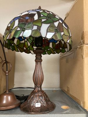 a lamp that is sitting on a shelf next to a box